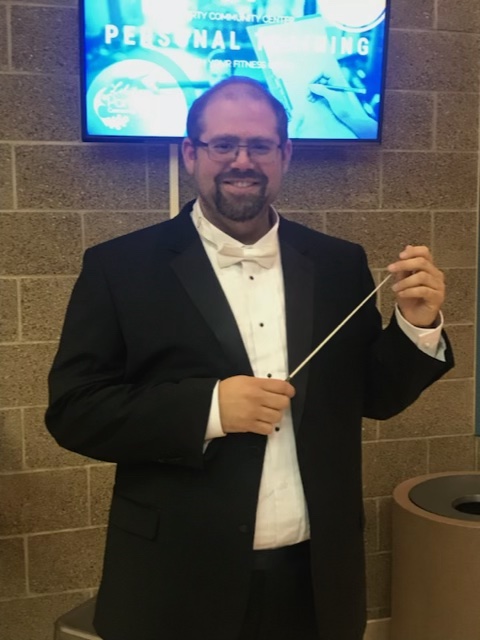 Parker Stanley smiles while holding a baton.