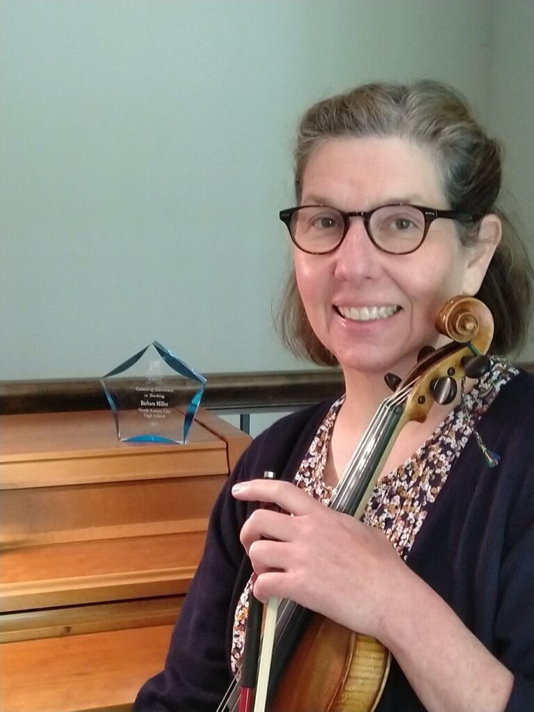 Barbara Miller holding a viola.
